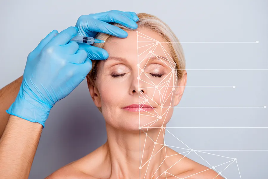 Aesthetic-Injectables-Clinic A mature blonde woman gets a facial injection. Get injectable aesthetic treatments from Healthy Aging Medical Centers of New Jersey in Northern New Jersey.
