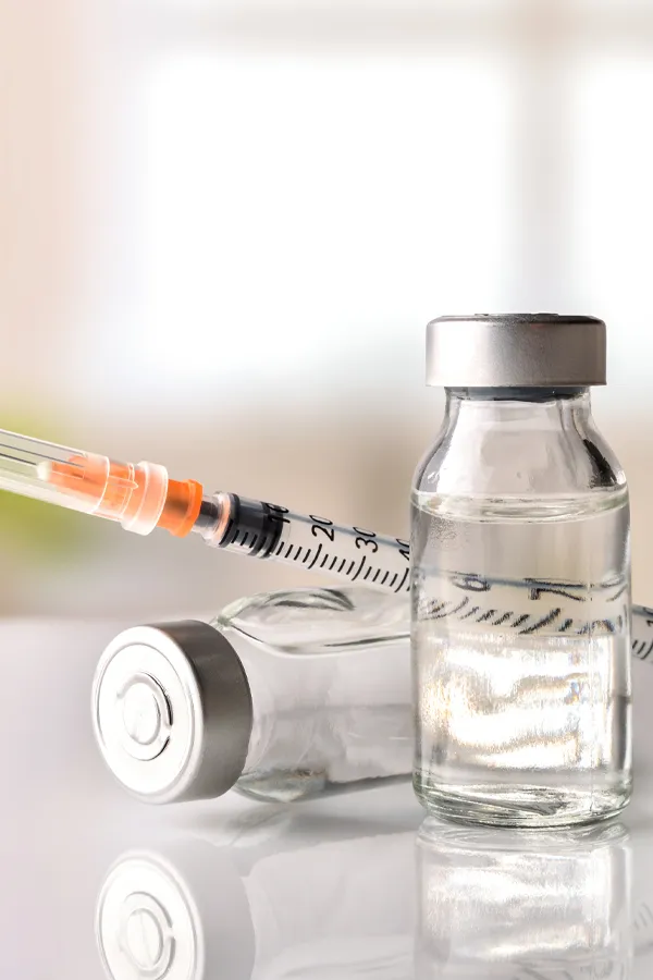 Juvederm-Fillers-Treatment Close-up of vials with fluid and a syringe. Get Juvederm fillers from Healthy Aging Medical Centers of New Jersey in Northern New Jersey.